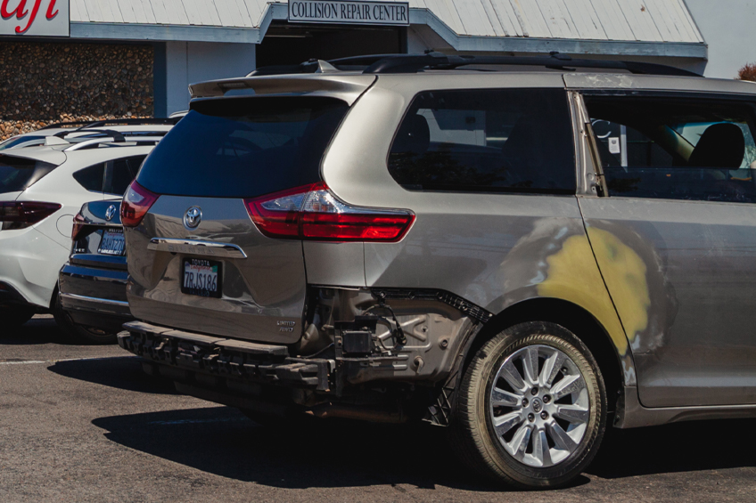 Backside of new silver car get damaged by accident